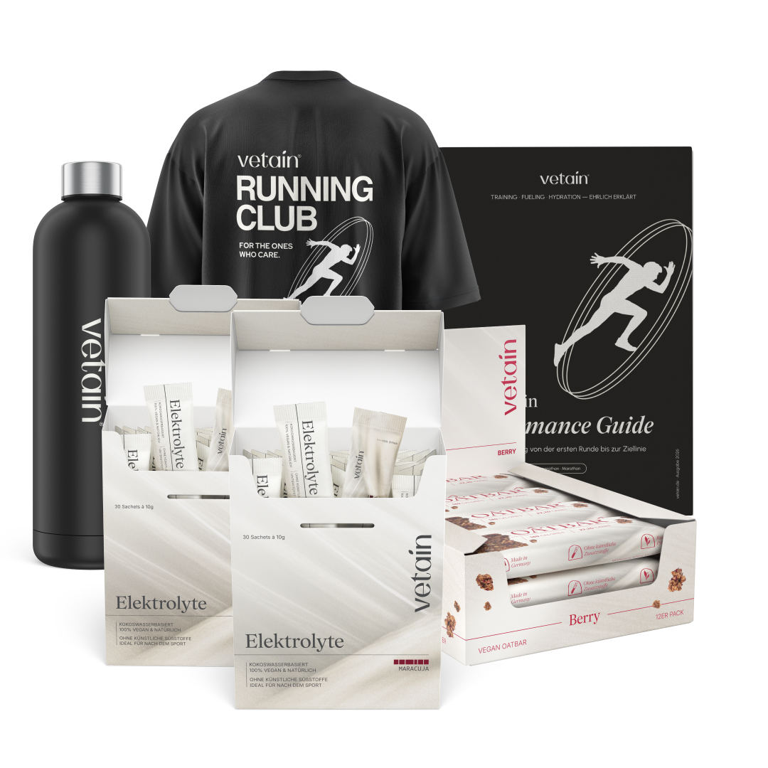 Vetain Performance Bundle isolated on a white background: black water bottle, Running Club T-shirt, two electrolyte boxes, 12-pack Oatbar Berry carton, and Performance Guide e-book.