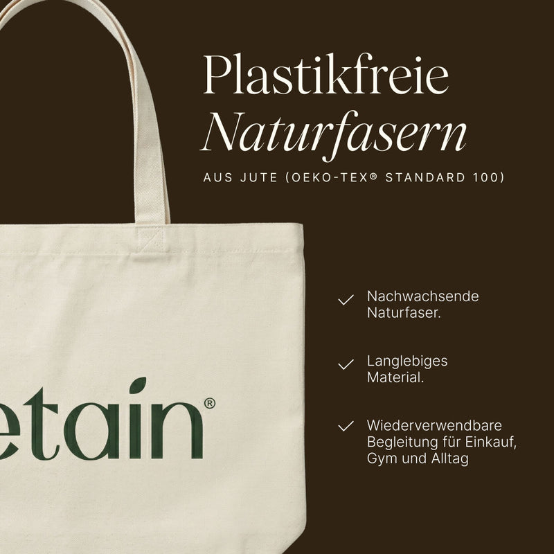 Nahaufnahme des Vetain Jutebeutels mit Henkel und Logo auf dunkelbraunem Hintergrund – Material aus Jute